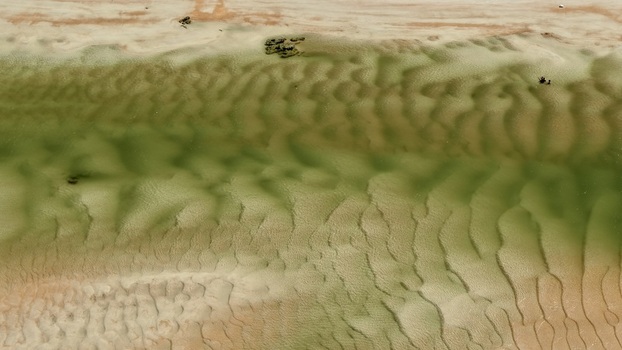 Aerial view of the sandbars and shallow tidal waters at Matanzas Inlet showcasing intricate ripple patterns in the sand in St. Johns County Florida United States. Aerial view of the sandbars and shallow tidal waters at Matanzas Inlet showcasing intricate ripple patterns in the sand in St. Johns County Florida United States.
