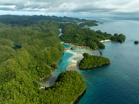 Aerial view of Bucas Grande featuring lush green islands turquoise waters hidden lagoons and small resort structures nestled among the dense tropical vegetation in Siargao Philippines. Aerial view of Bucas Grande featuring lush green islands turquoise waters hidden lagoons and small resort structures nestled among the dense tropical vegetation in Siargao Philippines.