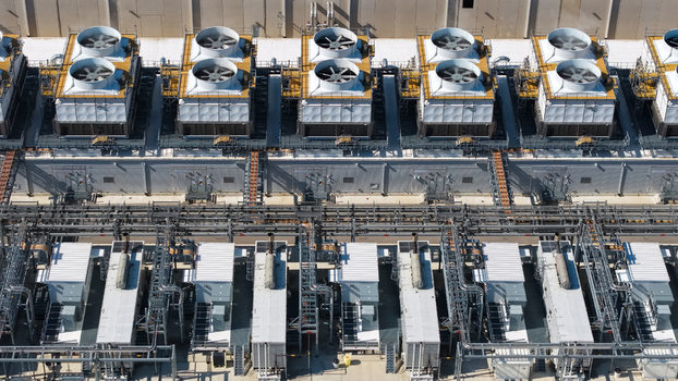Aerial view of industrial cooling towers and HVAC systems with complex piping on data center infrastructure in Columbus Ohio United States.
