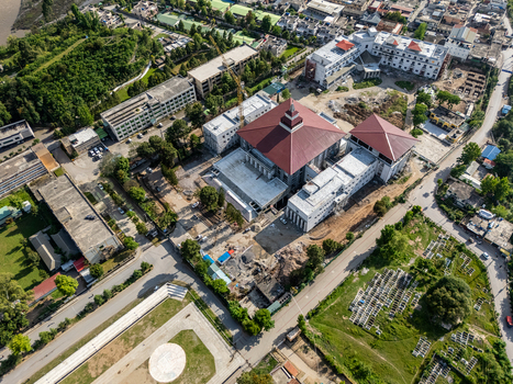 Aerial view of the Muzaffarabad Assembly Building complex featuring a prominent red roof surrounding construction areas and urban infrastructure in Muzaffarabad Azad Kashmir Pakistan. Aerial view of the Muzaffarabad Assembly Building complex featuring a prominent red roof surrounding construction areas and urban infrastructure in Muzaffarabad Azad Kashmir Pakistan.
