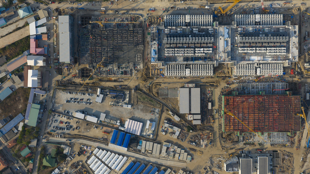 Aerial view of the Bridge Data Center under construction with cranes industrial structures and a parking lot in Khlong Tamru Chon Buri Thailand. Aerial view of the Bridge Data Center under construction with cranes industrial structures and a parking lot in Khlong Tamru Chon Buri Thailand.