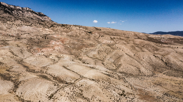 Aerial view of the arid rolling hills and rugged landscape near Cody Wyoming United States.