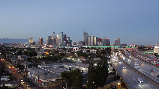 Aerial view of the Los Angeles skyline at twilight with busy highway traffic and urban buildings in Los Angeles California United States. Aerial view of the Los Angeles skyline at twilight with busy highway traffic and urban buildings in Los Angeles California United States.