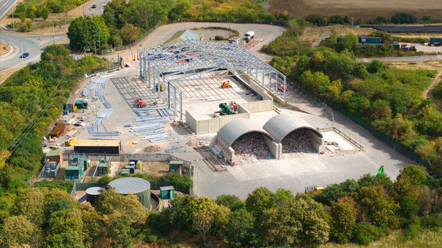 Aerial view of the Veolia Elstow waste management facility under construction showing the steel framework storage bunkers and surrounding greenery in Bedford England United Kingdom. Aerial view of the Veolia Elstow waste management facility under construction showing the steel framework storage bunkers and surrounding greenery in Bedford England United Kingdom.