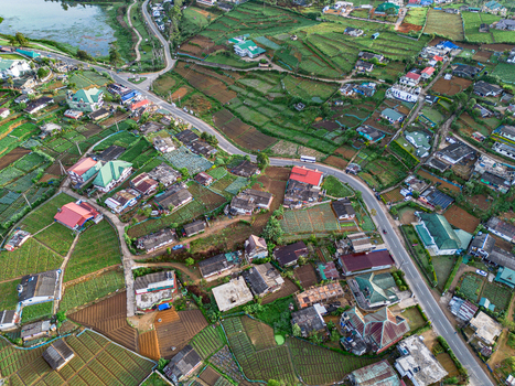 Aerial view of the town of Nuwara Eliya with its characteristic terraced agricultural fields colorful rooftops and winding roads nestled in the landscape of Nuwara Eliya Central Province Sri Lanka. Aerial view of the town of Nuwara Eliya with its characteristic terraced agricultural fields colorful rooftops and winding roads nestled in the landscape of Nuwara Eliya Central Province Sri Lanka.