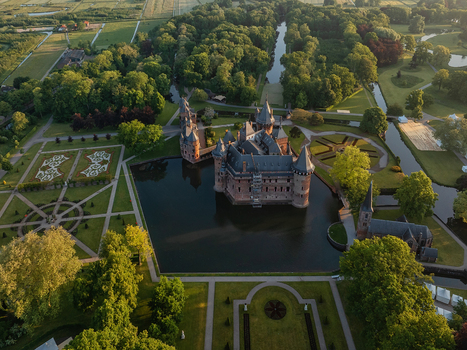 Aerial view of De Haar Castle with its medieval towers and moat surrounded by formal gardens and lush parkland in Utrecht Utrecht Netherlands. Aerial view of De Haar Castle with its medieval towers and moat surrounded by formal gardens and lush parkland in Utrecht Utrecht Netherlands.
