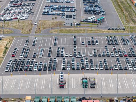 Aerial view of the Tesla Gigafactory Berlin Brandenburg parking lot filled with rows of new electric vehicles and transport trucks in Grunheide Mark Brandenburg Germany. Aerial view of the Tesla Gigafactory Berlin Brandenburg parking lot filled with rows of new electric vehicles and transport trucks in Grunheide Mark Brandenburg Germany.