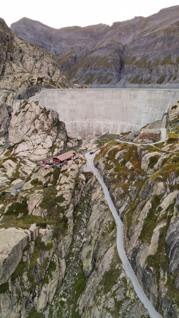 Aerial view of the Vieux Emosson dam and lake surrounded by rugged rocky mountains and alpine terrain in Finhaut Valais Switzerland. Aerial view of the Vieux Emosson dam and lake surrounded by rugged rocky mountains and alpine terrain in Finhaut Valais Switzerland.