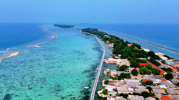 Aerial view of Pulau Tidung Besar with its long bridge connecting the islands surrounded by turquoise coral reefs and clear water in South Kepulauan Seribu Jakarta Indonesia. Aerial view of Pulau Tidung Besar with its long bridge connecting the islands surrounded by turquoise coral reefs and clear water in South Kepulauan Seribu Jakarta Indonesia.