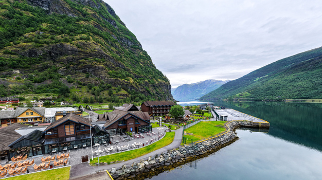 Aerial view of Flam village with its wooden buildings waterfront restaurant and surrounding mountains by the fjord in Flam Vestland Norway. Aerial view of Flam village with its wooden buildings waterfront restaurant and surrounding mountains by the fjord in Flam Vestland Norway.