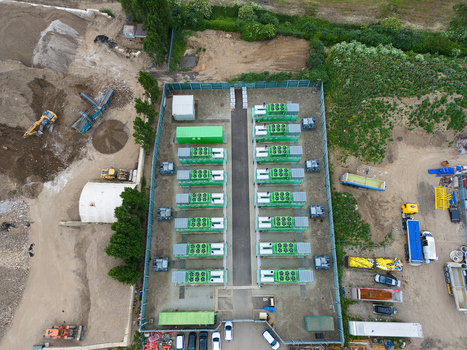 Aerial view of Damhead Creek Power Station Battery Energy Storage Systems BESS with rows of green containers in a fenced area at an industrial site Rochester England United Kingdom. Aerial view of Damhead Creek Power Station Battery Energy Storage Systems BESS with rows of green containers in a fenced area at an industrial site Rochester England United Kingdom.