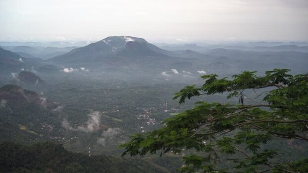 View of a lush valley and distant mountains in Sri Lanka.