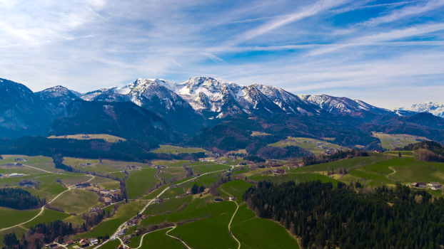 Aerial view of snow capped peaks meeting verdant valleys under a vast sky creating a serene vista of nature s grandeur Windischgarsten Upper Austria Austria. Aerial view of snow capped peaks meeting verdant valleys under a vast sky creating a serene vista of nature s grandeur Windischgarsten Upper Austria Austria.