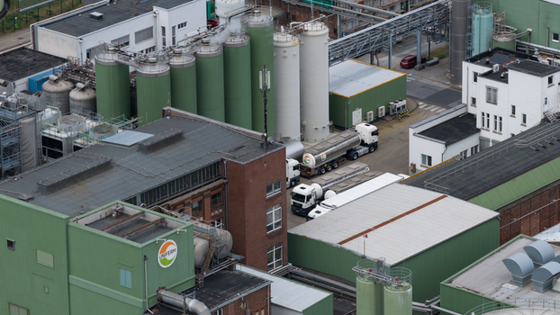 Monheim am Rhein Germany 04 September 2026 Aerial view of the UNIFERM GmbH Co. KG industrial facility with green storage silos brick buildings and trucks in the yard.