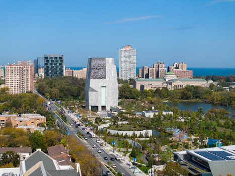 Aerial view of The Obama Presidential Center surrounded by lush parkland a lake and the Chicago skyline in the background in Chicago Illinois United States. Aerial view of The Obama Presidential Center surrounded by lush parkland a lake and the Chicago skyline in the background in Chicago Illinois United States.