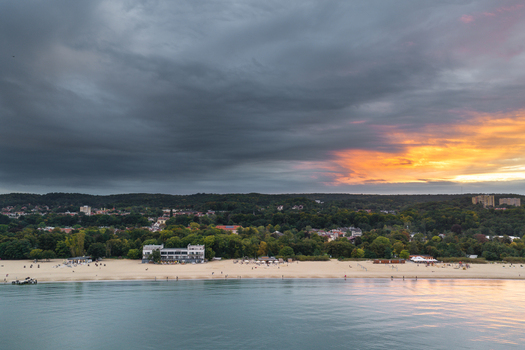 Aerial view of the sandy beach and coastline of Sopot with dramatic sunset clouds over the Baltic Sea in Sopot Pomeranian Voivodeship Poland. Aerial view of the sandy beach and coastline of Sopot with dramatic sunset clouds over the Baltic Sea in Sopot Pomeranian Voivodeship Poland.