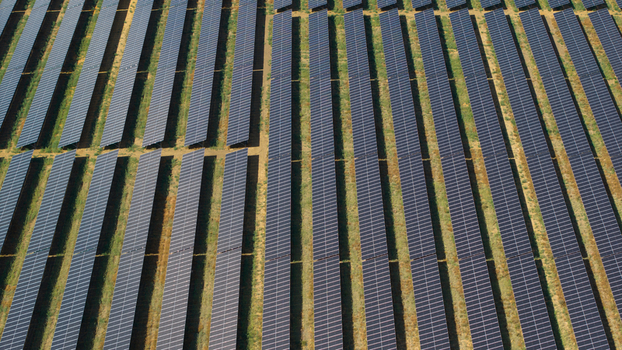 Aerial view of the Eaton Socon solar farm and battery energy storage systems with rows of photovoltaic panels arranged in a field in St. Neots England United Kingdom. Aerial view of the Eaton Socon solar farm and battery energy storage systems with rows of photovoltaic panels arranged in a field in St. Neots England United Kingdom.