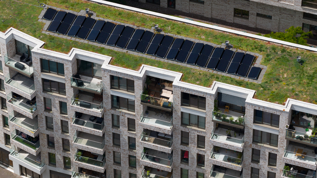 Aerial view of a modern apartment building with a green roof and solar panels along the Cruquiusweg in Amsterdam Noord Holland Netherlands.