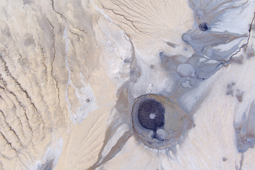 Aerial view of the Mud Volcanoes of Paclele Mari showing unique grey mud craters dry cracked earth and intricate erosion patterns in Paclele Buzau County Romania.