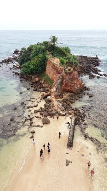 Aerial view of Parrot Rock and people on the beach Sri Lanka. Aerial view of Parrot Rock and people on the beach Sri Lanka.