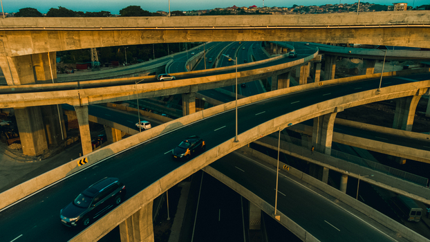 Aerial view of the Pokuase Interchange featuring multi level concrete overpasses and traffic flowing during golden hour in Ga North Municipal Greater Accra Region Ghana. Aerial view of the Pokuase Interchange featuring multi level concrete overpasses and traffic flowing during golden hour in Ga North Municipal Greater Accra Region Ghana.
