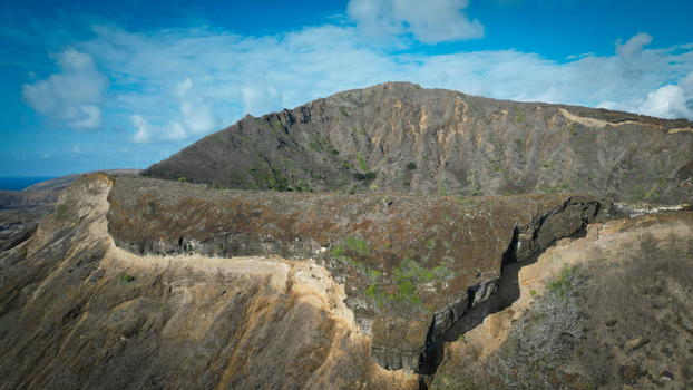 Aerial view of rugged Koko Head volcano crater rim where the arid steep slopes meet the vast blue Pacific horizon Honolulu Hawaii United States. Aerial view of rugged Koko Head volcano crater rim where the arid steep slopes meet the vast blue Pacific horizon Honolulu Hawaii United States.