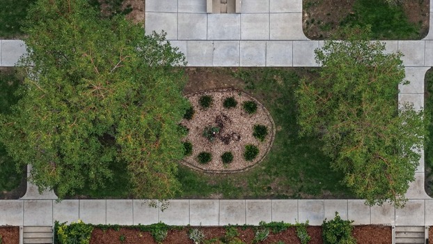 Aerial view of the landscaped grounds at Cherry Creek featuring lush green trees concrete walkways and a central circular garden bed in Denver Colorado United States. Aerial view of the landscaped grounds at Cherry Creek featuring lush green trees concrete walkways and a central circular garden bed in Denver Colorado United States.