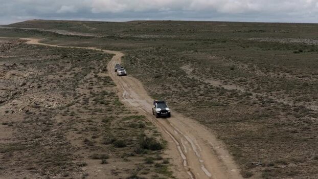 Aerial view of off road vehicles in the desert Kazakhstan.