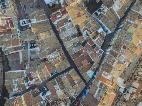 Aerial view of the dense historic center with terracotta rooftops and narrow streets under warm sunlight La Vila Joiosa Valencian Community Spain. Aerial view of the dense historic center with terracotta rooftops and narrow streets under warm sunlight La Vila Joiosa Valencian Community Spain.