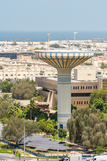 Aerial view of the iconic mushroom shaped water tower surrounded by lush greenery solar panels and urban architecture with the sea in the distance in Dubai Dubai United Arab Emirates. Aerial view of the iconic mushroom shaped water tower surrounded by lush greenery solar panels and urban architecture with the sea in the distance in Dubai Dubai United Arab Emirates.