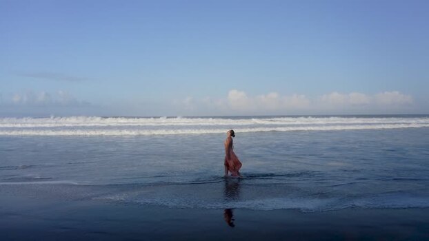 Aerial view of a woman walking on a beach Indonesia. Aerial view of a woman walking on a beach Indonesia.