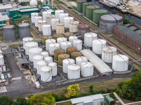 Aerial view of TanQuid Tanklager Berlin with numerous industrial storage tanks pipelines and rail tracks in an urban industrial area in Berlin Berlin Germany.