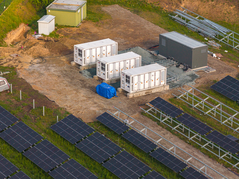 Aerial view of FVE Bohumilice solar farm with rows of photovoltaic panels and white battery storage containers on a dirt field in Klobouky u Brna Jihomoravsky kraj Czechia. Aerial view of FVE Bohumilice solar farm with rows of photovoltaic panels and white battery storage containers on a dirt field in Klobouky u Brna Jihomoravsky kraj Czechia.