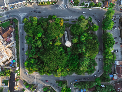 Aerial view of Taman Samarendah surrounded by lush green trees and urban roads with traffic in Samarinda East Kalimantan Indonesia. Aerial view of Taman Samarendah surrounded by lush green trees and urban roads with traffic in Samarinda East Kalimantan Indonesia.