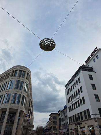 Hanover Germany 29 March 2026 View of the urban streetscape in Hanover featuring the Europa Haus and Peek and Cloppenburg buildings with a decorative hanging sculpture suspended above the street.