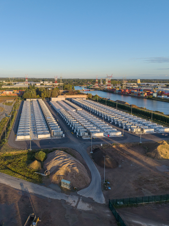 Aerial view of the Cargovil battery energy storage system with rows of white containers industrial infrastructure and power lines near the canal in Vilvoorde Vlaanderen Belgium. Aerial view of the Cargovil battery energy storage system with rows of white containers industrial infrastructure and power lines near the canal in Vilvoorde Vlaanderen Belgium.