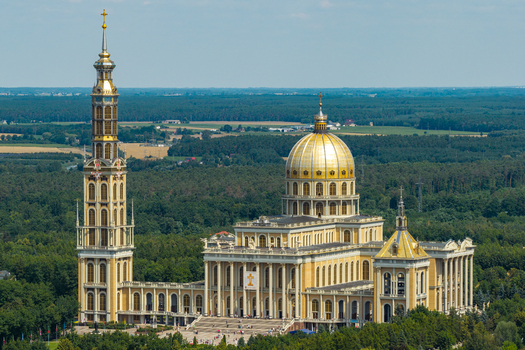 Lichen Stary Poland 25 July 2026 Aerial view of the Basilica of Our Lady of Lichen featuring its golden dome and tall bell tower surrounded by lush forests.