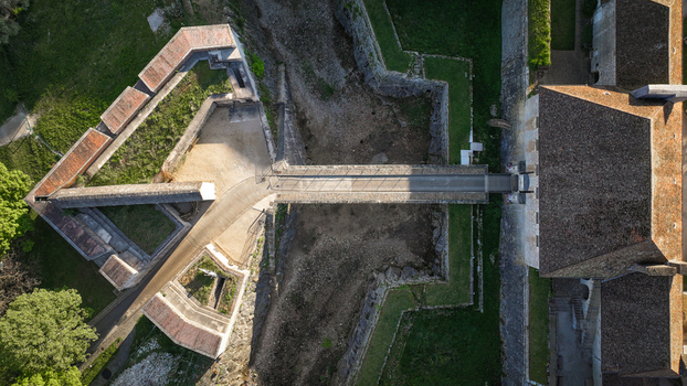 Aerial view of the historic stone fortifications and geometric bastions of the Besancon Citadel surrounded by green grass in Besancon Bourgogne Franche Comte France. Aerial view of the historic stone fortifications and geometric bastions of the Besancon Citadel surrounded by green grass in Besancon Bourgogne Franche Comte France.