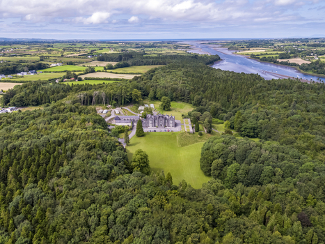 Ballina Ireland 25 September 2026 Aerial view of Belleek Castle Hotel surrounded by lush forests and meadows with the River Moy winding through the landscape in the distance. Ballina Ireland 25 September 2026 Aerial view of Belleek Castle Hotel surrounded by lush forests and meadows with the River Moy winding through the landscape in the distance.