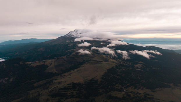 Aerial view of the Iztaccihuatl Popocatepetl National Park with snow capped peaks partially obscured by clouds over the rugged volcanic landscape in Amecameca de Juarez Estado de Mexico Mexico.