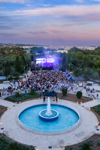 Attard Malta 20 September 2026 Aerial view of Park Nazzjonali Ta Qali featuring a large crowd gathered at an outdoor music festival with a central fountain and stage lighting. Attard Malta 20 September 2026 Aerial view of Park Nazzjonali Ta Qali featuring a large crowd gathered at an outdoor music festival with a central fountain and stage lighting.