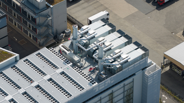 Aerial view of the Equinix Data Center rooftop featuring industrial cooling units ventilation systems and exhaust stacks in Frankfurt am Main Hessen Germany.