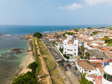 Aerial view of the historic Meeran Jumma Mosque and the coastal ramparts of the fort overlooking the Indian Ocean in Galle Southern Province Sri Lanka. Aerial view of the historic Meeran Jumma Mosque and the coastal ramparts of the fort overlooking the Indian Ocean in Galle Southern Province Sri Lanka.