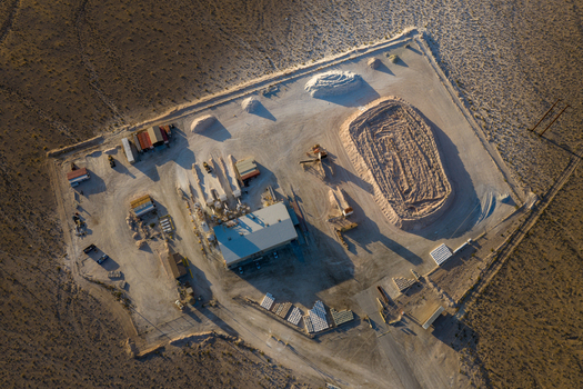 Aerial view of an industrial mining facility with white mineral piles and heavy machinery in a desert landscape Enterprise Nevada United States. Aerial view of an industrial mining facility with white mineral piles and heavy machinery in a desert landscape Enterprise Nevada United States.