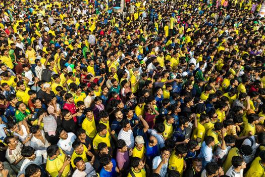 Dhaka Bangladesh 20 June 2026 Aerial view of a massive crowd of football fans in yellow jerseys gathered at Dhaka University Campus creating a vibrant sea of color. Dhaka Bangladesh 20 June 2026 Aerial view of a massive crowd of football fans in yellow jerseys gathered at Dhaka University Campus creating a vibrant sea of color.
