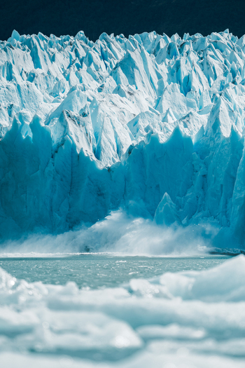 View of the jagged blue ice formations of the Perito Moreno Glacier rising above the glacial water in Perito Moreno Santa Cruz Province Argentina. View of the jagged blue ice formations of the Perito Moreno Glacier rising above the glacial water in Perito Moreno Santa Cruz Province Argentina.