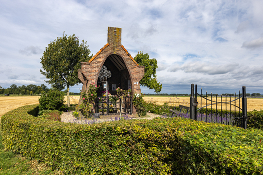 View of Kapel op De Heuvel a small brick shrine surrounded by a green hedge and flowers in Bemmel Gelderland Netherlands. View of Kapel op De Heuvel a small brick shrine surrounded by a green hedge and flowers in Bemmel Gelderland Netherlands.