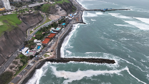 Aerial view of the coastal area of Barranco with waves crashing against the breakwater cliffs and urban infrastructure along the Pacific Ocean in Barranco Lima Province Peru. Aerial view of the coastal area of Barranco with waves crashing against the breakwater cliffs and urban infrastructure along the Pacific Ocean in Barranco Lima Province Peru.