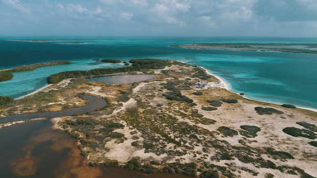 Aerial view of the Los Roques archipelago featuring turquoise waters sandy beaches and coastal vegetation in Los Roques Dependencias Federale Venezuela. Aerial view of the Los Roques archipelago featuring turquoise waters sandy beaches and coastal vegetation in Los Roques Dependencias Federale Venezuela.
