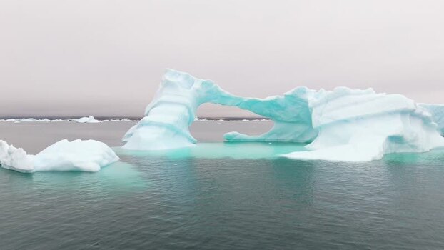 Aerial view of a large iceberg with an arch Greenland. Aerial view of a large iceberg with an arch Greenland.
